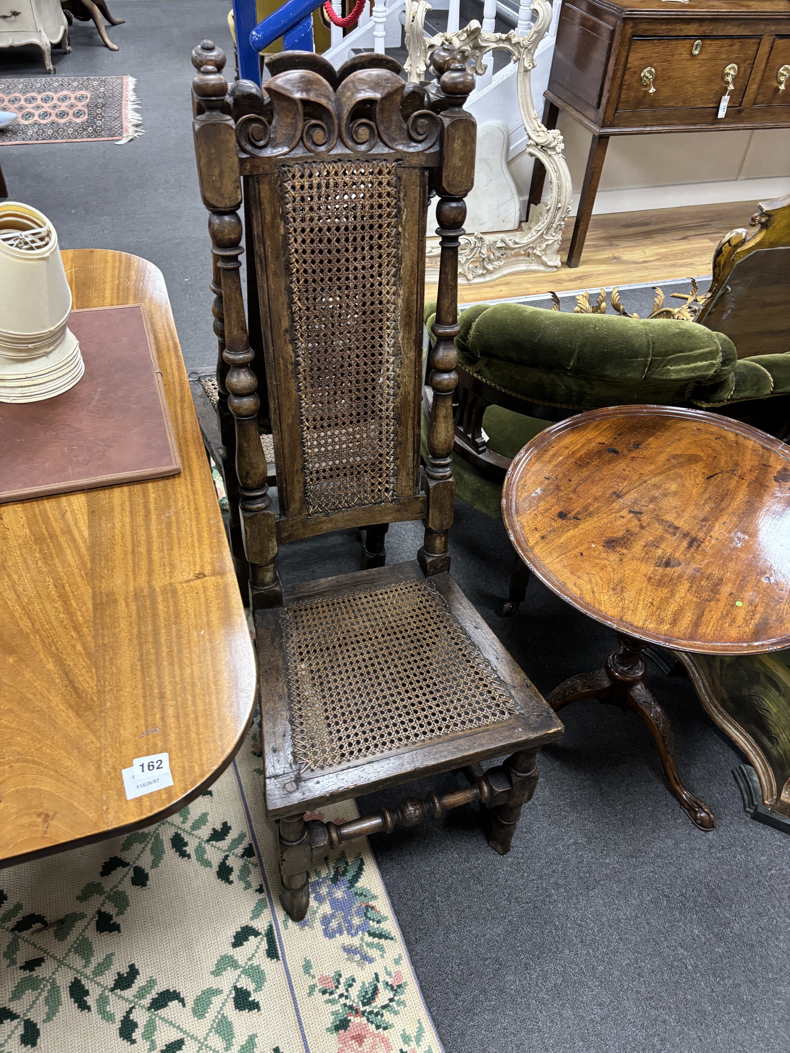 A pair of late 17th century walnut and caned high back dining chairs, height 116cm